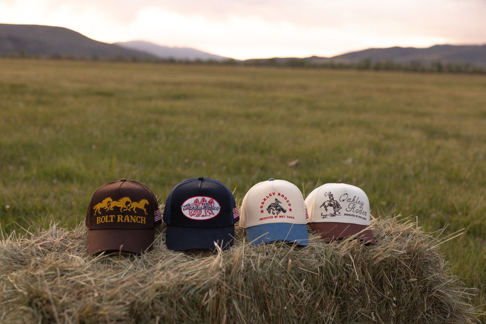 Bolt Ranch hat collection on a hay bale