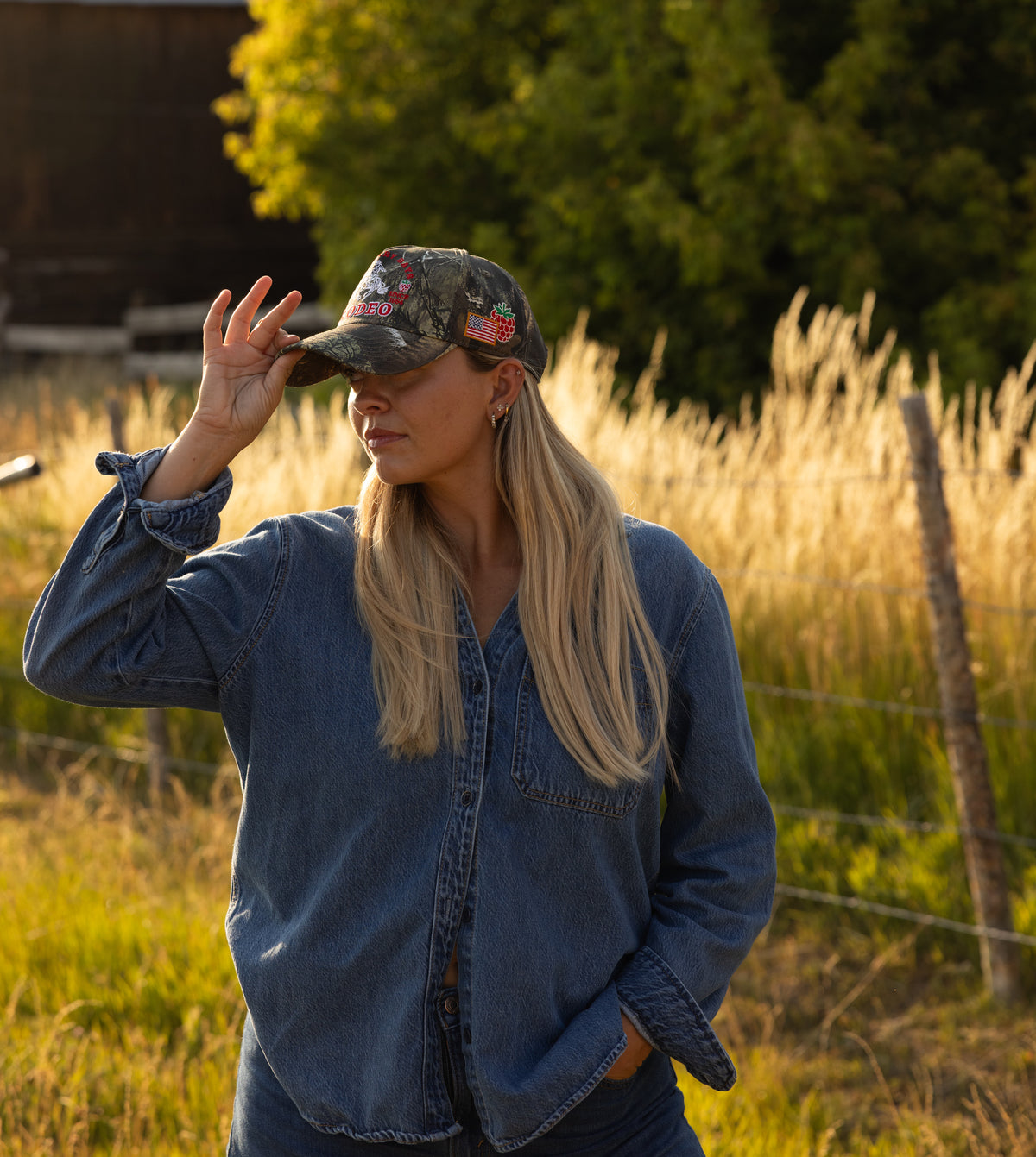Woman in a camo Bull River cap and denim jacket