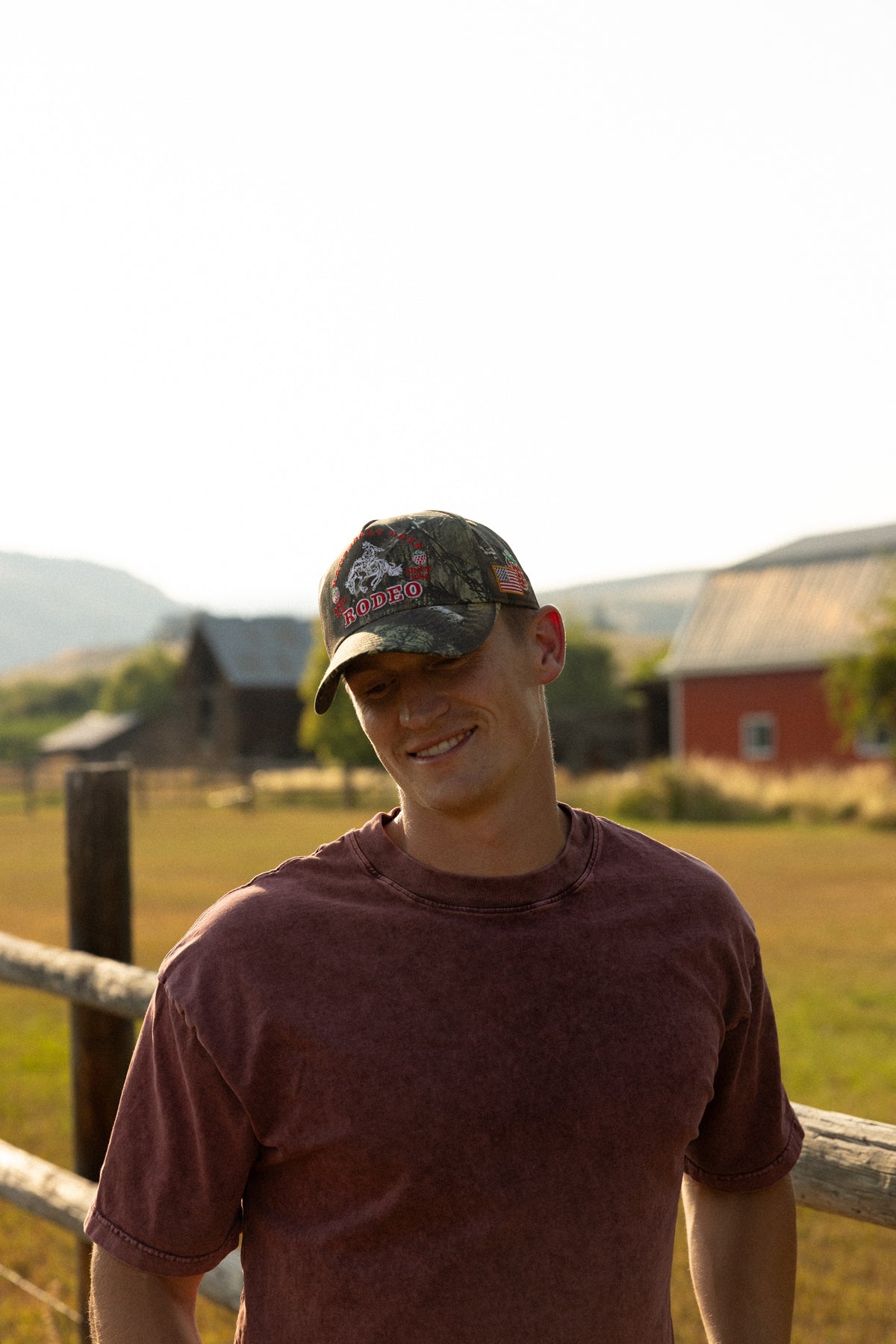 Man in a camo Bull River cap outside a barn