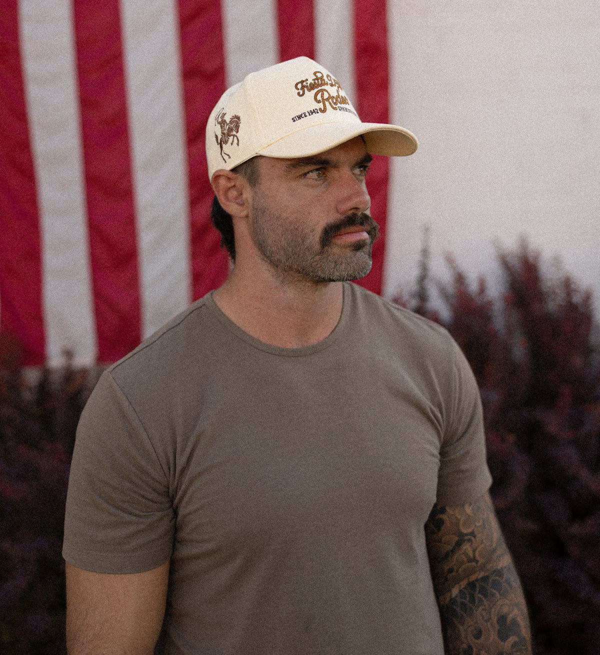 Man in a Bull River cap in front of an American flag