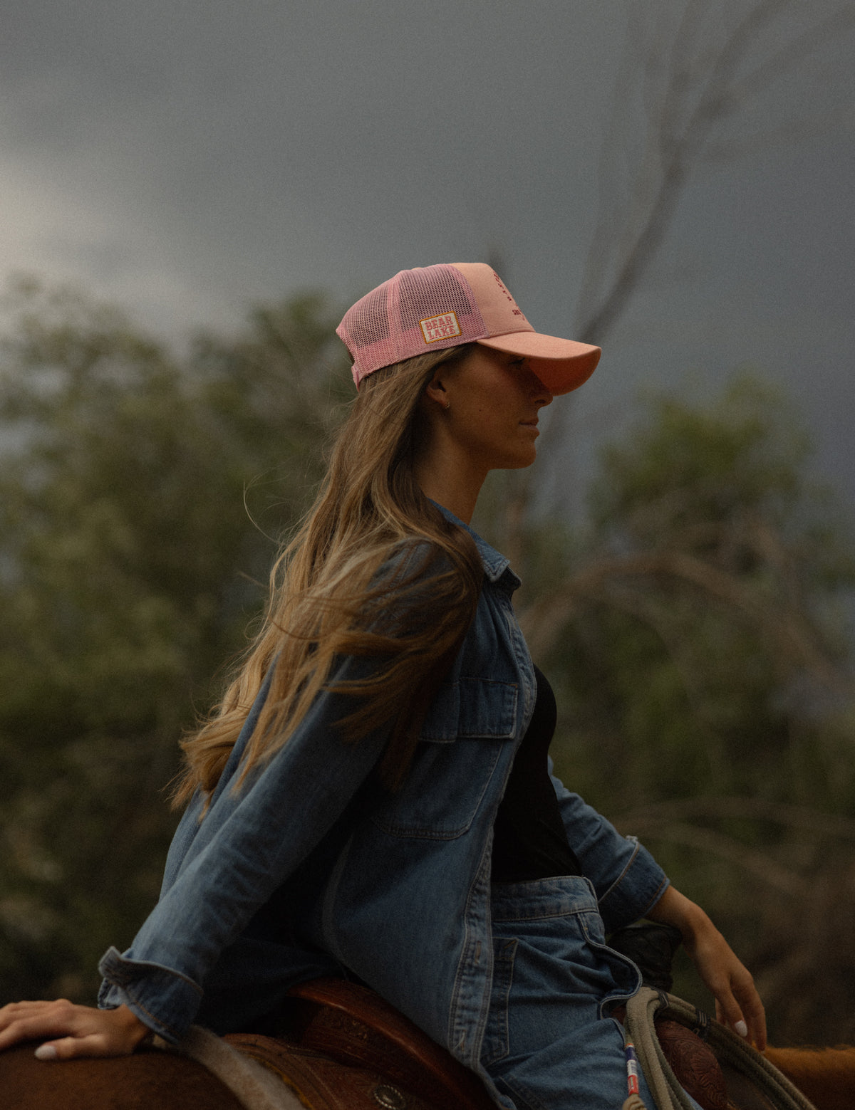 Portrait in a denim jacket and Bull River rodeo cap