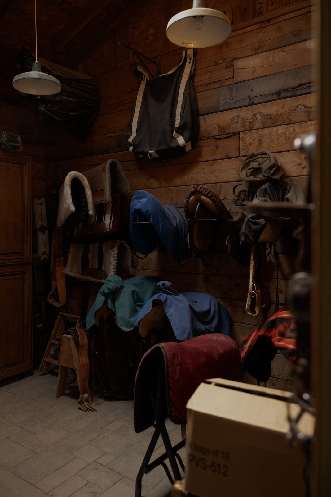 Saddles and tack hanging in the barn at Bull River