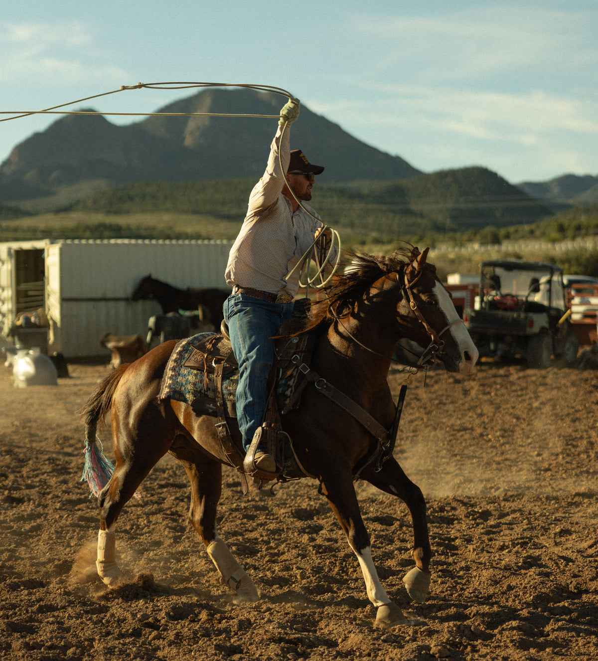 Bull River Supply roper swinging a rope in an arena