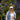 Woman wearing an ivory and royal blue SOFT GIRL trucker hat, front view