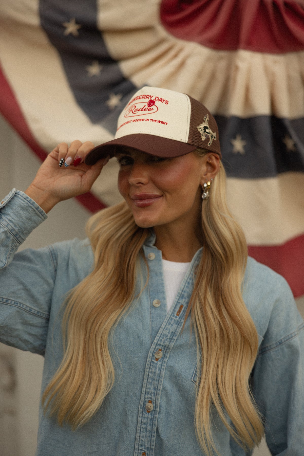 Woman in a denim jacket and Bull River bronco cap